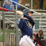 Justin Bosland completing his swing after hitting a long home run